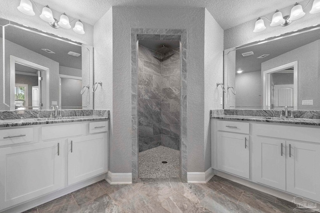 591 Nowak Rd, Cantonment, FL 32533 - full bath featuring walk in shower, a textured wall, two vanities, baseboards, and a textured ceiling