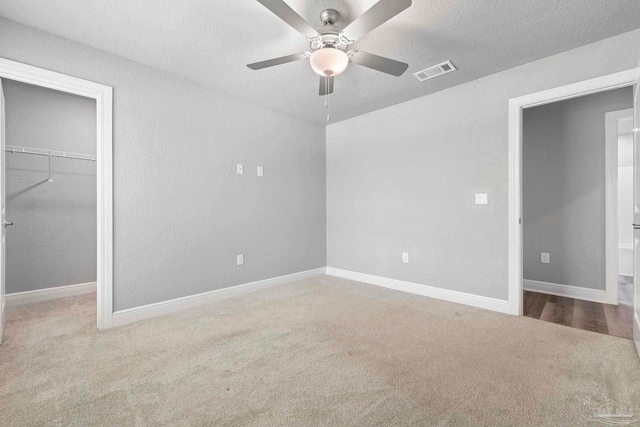 591 Nowak Rd, Cantonment, FL 32533 - unfurnished bedroom featuring carpet flooring, a spacious closet, a closet, baseboards, and a ceiling fan