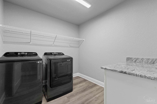 591 Nowak Rd, Cantonment, FL 32533 - laundry room with light wood-type flooring, separate washer and dryer, and baseboards