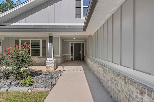 591 Nowak Rd, Cantonment, FL 32533 - entrance to property featuring board and batten siding, a porch, brick siding, and a shingled roof
