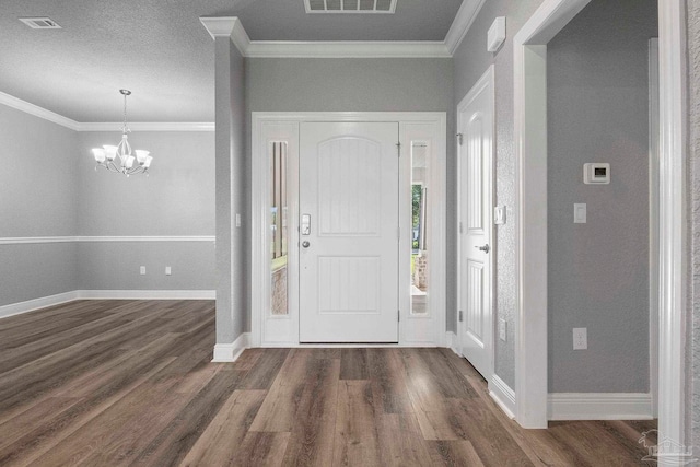 591 Nowak Rd, Cantonment, FL 32533 - entryway featuring dark wood finished floors, baseboards, a chandelier, and ornamental molding