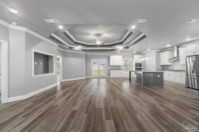 591 Nowak Rd, Cantonment, FL 32533 - unfurnished living room with a tray ceiling, ornamental molding, ceiling fan, dark wood-style flooring, and baseboards