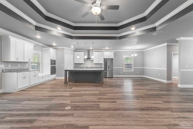 591 Nowak Rd, Cantonment, FL 32533 - kitchen featuring stainless steel appliances, wall chimney exhaust hood, ornamental molding, plenty of natural light, and open floor plan