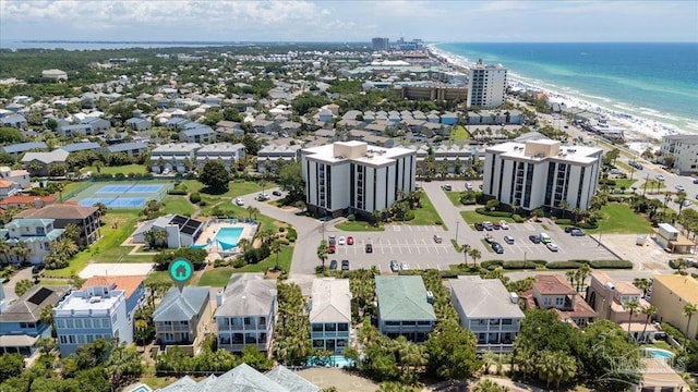 drone / aerial view with a water view and a beach view