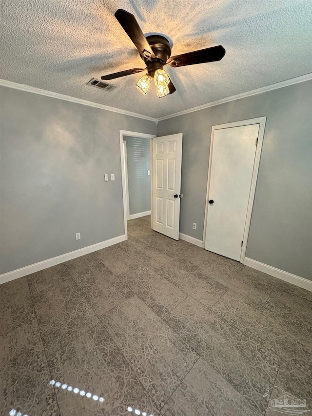 unfurnished bedroom with a textured ceiling, ornamental molding, visible vents, and baseboards