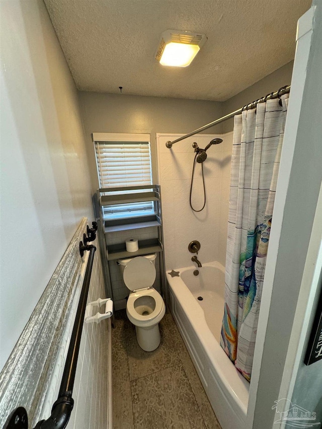 bathroom with shower / bath combo, a textured ceiling, and toilet