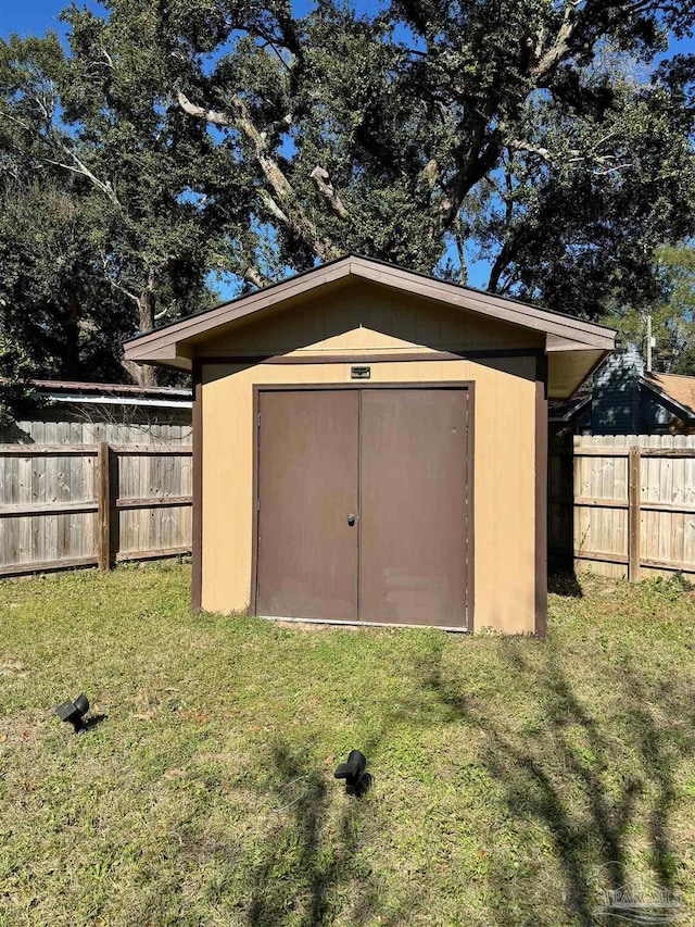 view of shed with a fenced backyard