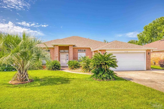 view of front facade with a front yard and a garage