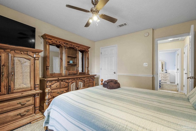 bedroom featuring ceiling fan, carpet flooring, and a textured ceiling