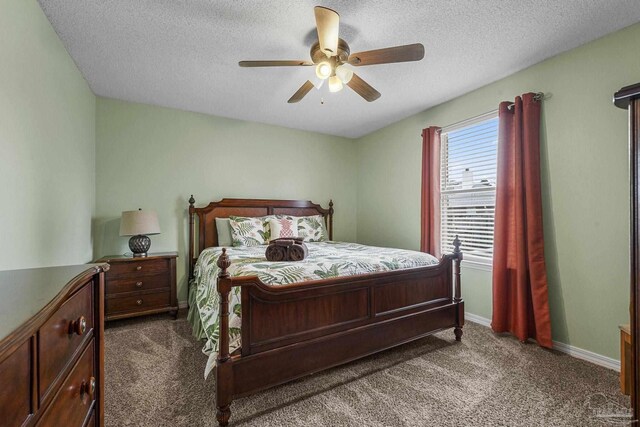 carpeted bedroom featuring a textured ceiling and ceiling fan