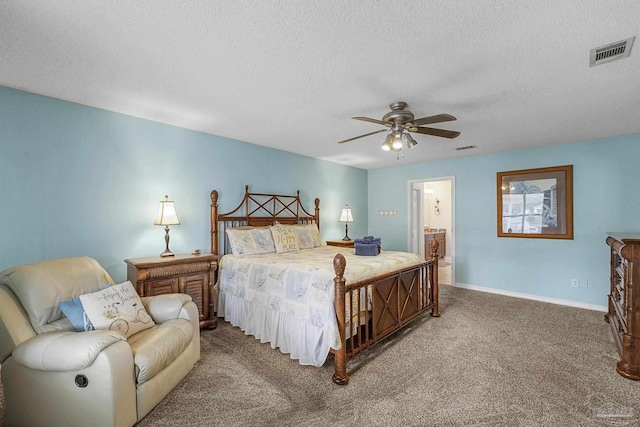 carpeted bedroom with ceiling fan, connected bathroom, and a textured ceiling