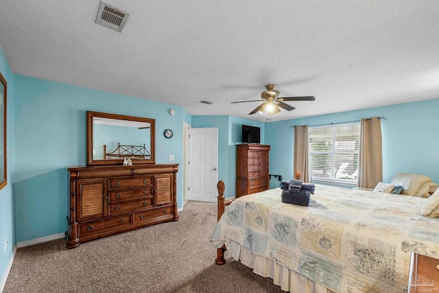 carpeted bedroom featuring a textured ceiling and ceiling fan