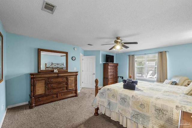 bedroom featuring ceiling fan, a textured ceiling, and light colored carpet