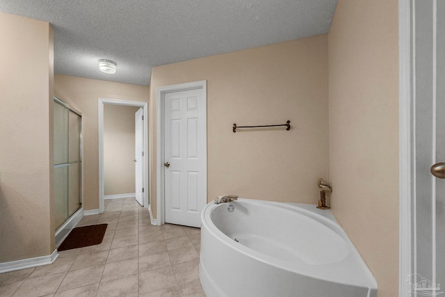 bathroom with shower with separate bathtub, a textured ceiling, and tile patterned flooring