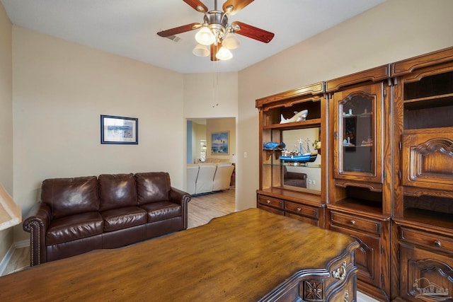 living room featuring hardwood / wood-style floors and ceiling fan