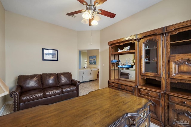 living room featuring hardwood / wood-style floors and ceiling fan