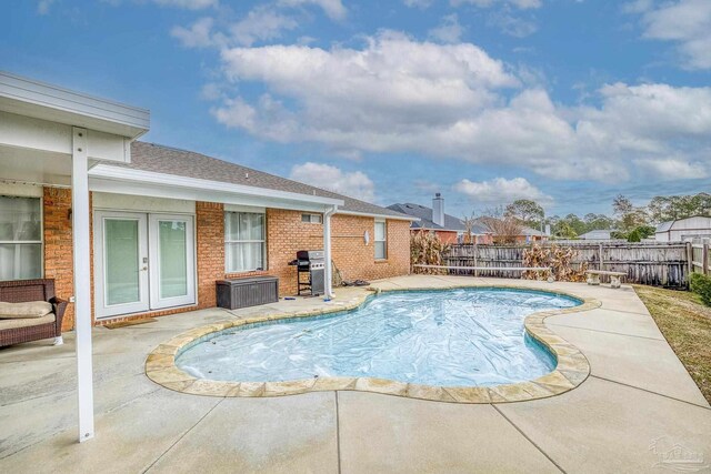 view of swimming pool with a patio, french doors, and grilling area