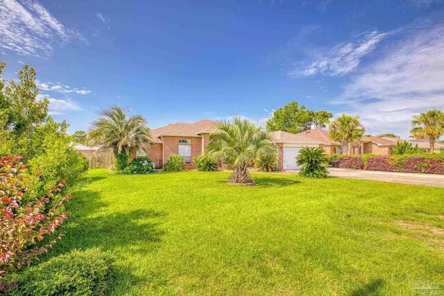 view of front of property with a garage and a front yard