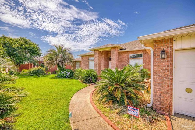 entrance to property with a lawn