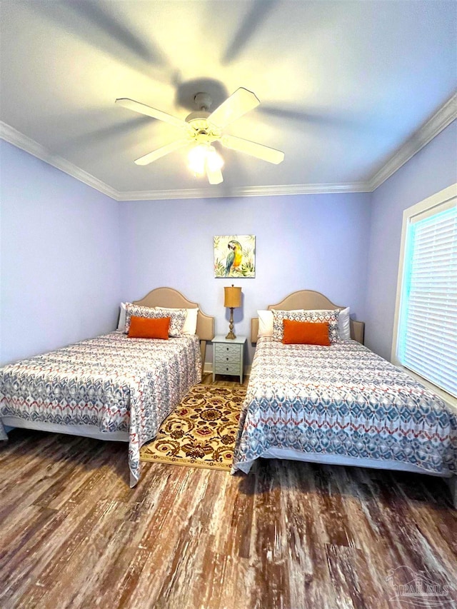 bedroom with hardwood / wood-style flooring, ornamental molding, and ceiling fan