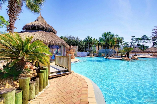 community pool with a gazebo and a patio