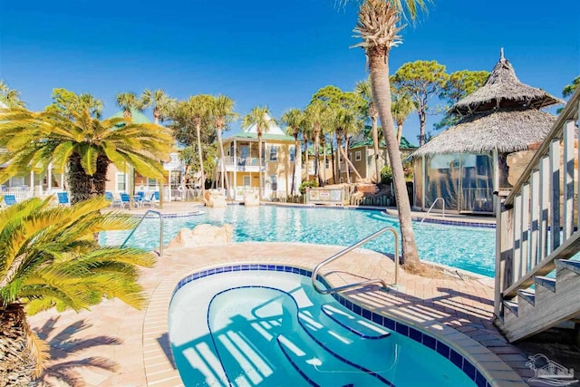 view of pool featuring a patio area and a hot tub