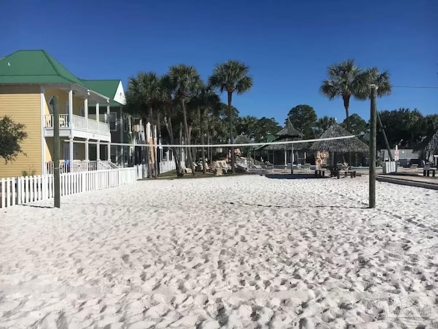 view of property's community with fence and volleyball court