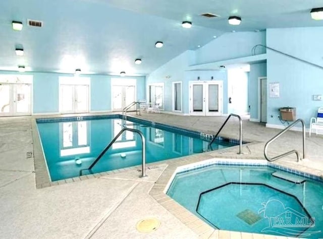 view of swimming pool with french doors