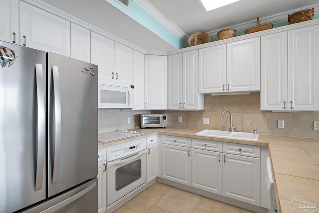 4050 Indigo Dr Unit 102, Pensacola, FL 32507 - kitchen featuring white appliances, a sink, white cabinets, and ornamental molding