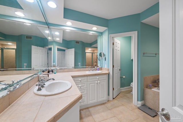 4050 Indigo Dr Unit 102, Pensacola, FL 32507 - bathroom featuring a stall shower, toilet, recessed lighting, double vanity, and baseboards