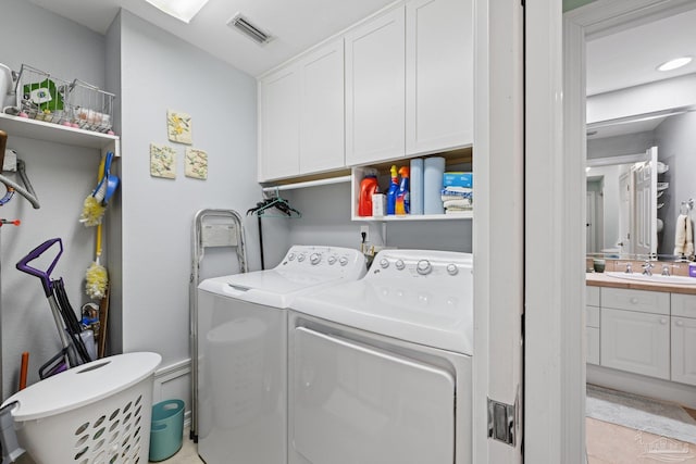 4050 Indigo Dr Unit 102, Pensacola, FL 32507 - laundry area with cabinet space, washing machine and clothes dryer, and light tile patterned floors