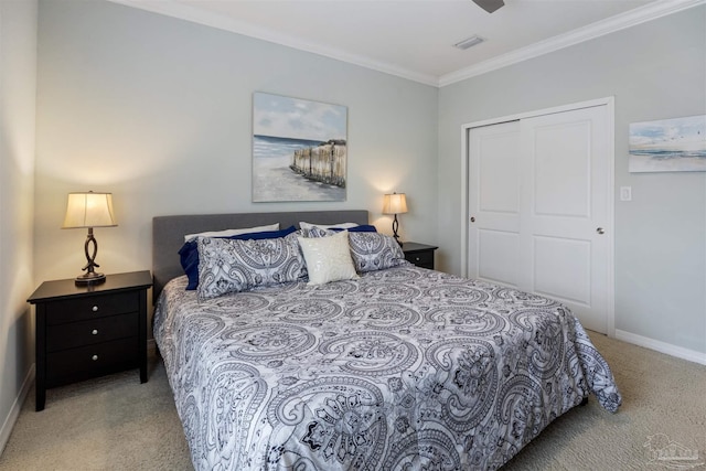 bedroom featuring crown molding, light carpet, and a closet