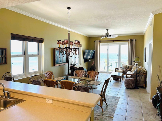 dining space featuring ceiling fan, ornamental molding, a textured ceiling, and light tile patterned flooring