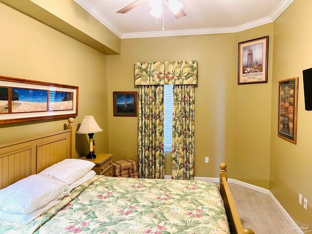 bedroom featuring ornamental molding, baseboards, light wood finished floors, and a ceiling fan