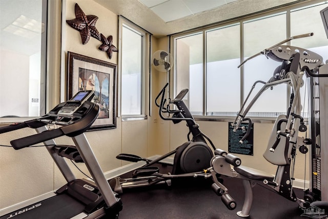 workout area featuring baseboards