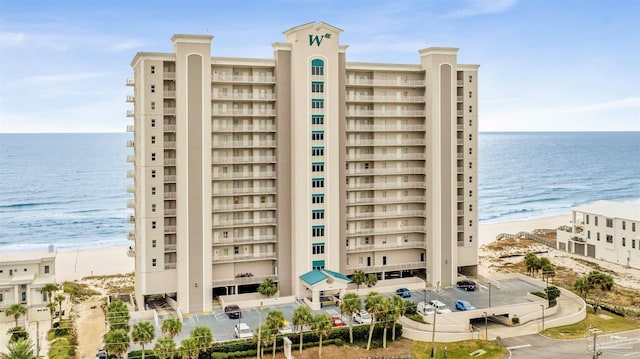 view of property with a view of the beach and a water view