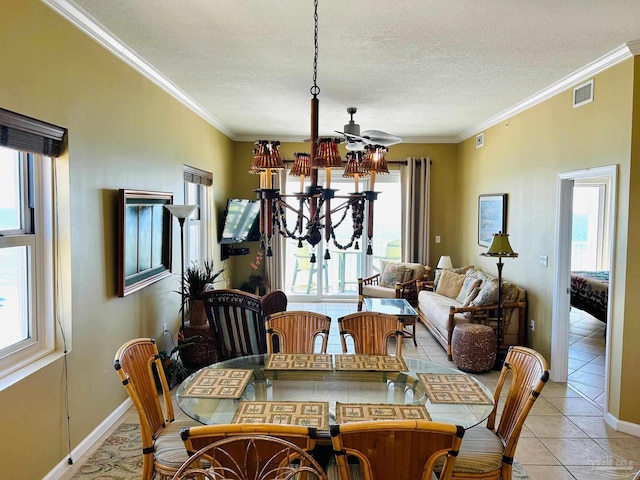 dining room with a textured ceiling, light tile patterned flooring, visible vents, and crown molding