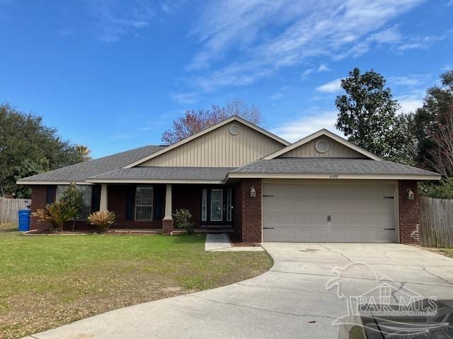 single story home featuring brick siding, fence, a garage, driveway, and a front lawn