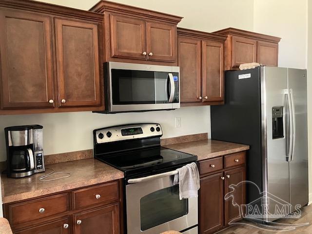 kitchen with appliances with stainless steel finishes and dark countertops