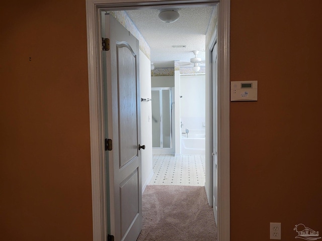 corridor with a textured ceiling