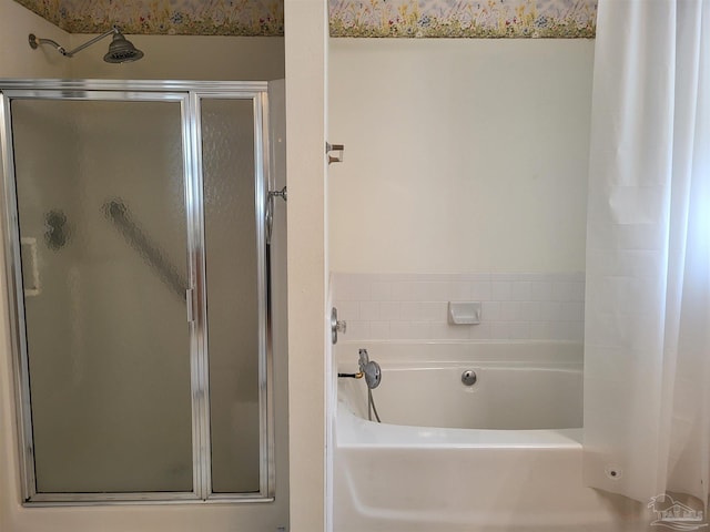 bathroom featuring shower with separate bathtub