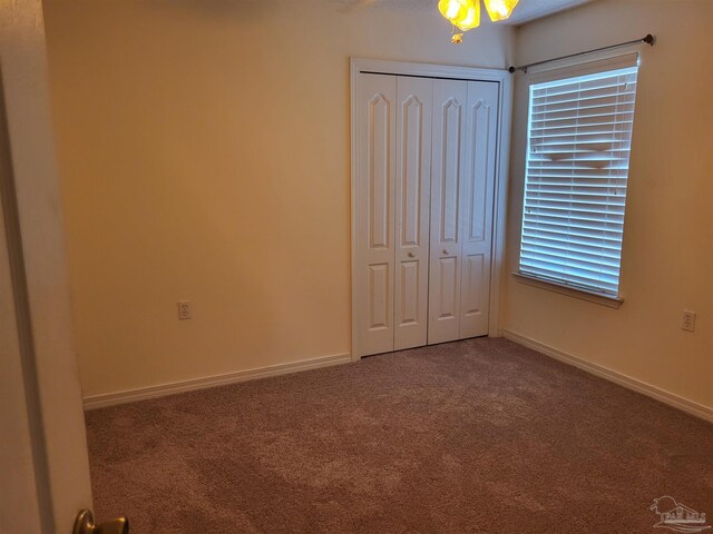 unfurnished bedroom with a closet and carpet