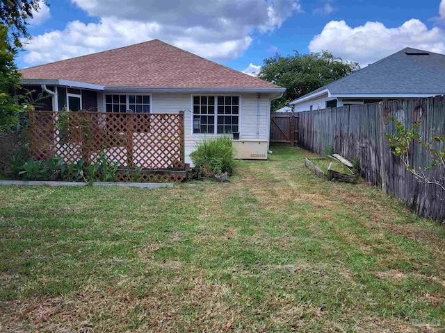 back of property with a lawn