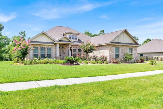 craftsman inspired home with brick siding, board and batten siding, and a front yard