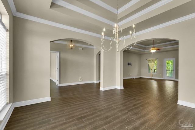 unfurnished room featuring ceiling fan with notable chandelier, a raised ceiling, crown molding, and dark wood-type flooring