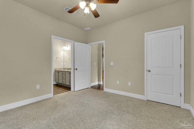 unfurnished bedroom featuring carpet flooring, connected bathroom, sink, and ceiling fan