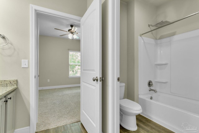 full bathroom with shower / bath combination, hardwood / wood-style flooring, toilet, vanity, and ceiling fan