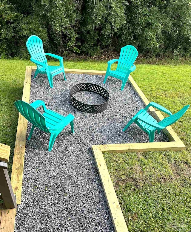 view of jungle gym with a fire pit and a lawn