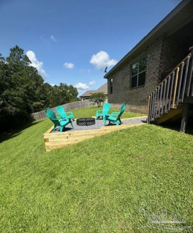 view of yard with a fire pit