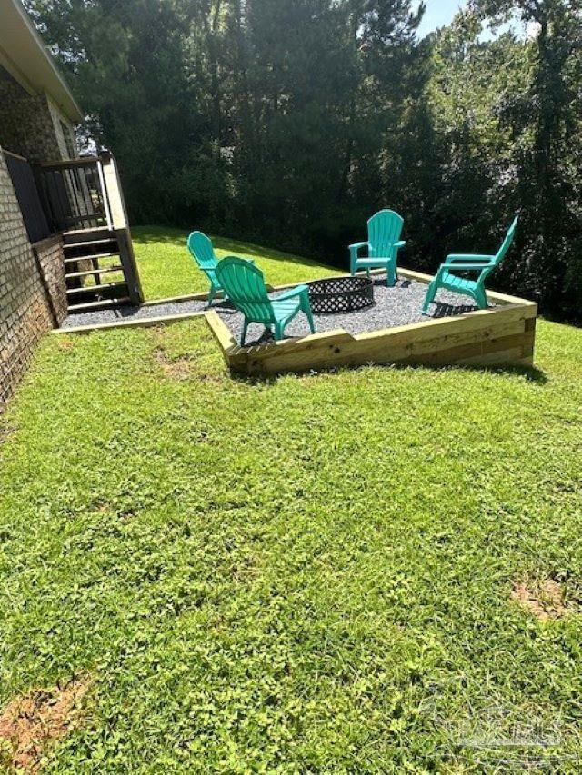 view of yard with an outdoor fire pit and a wooden deck